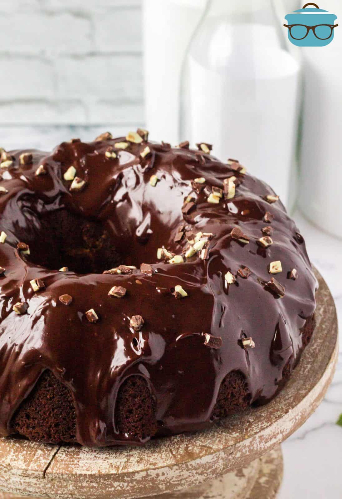 Mint Chocolate Bundt Cake covered in ganache and topped with chopped Andes mints.