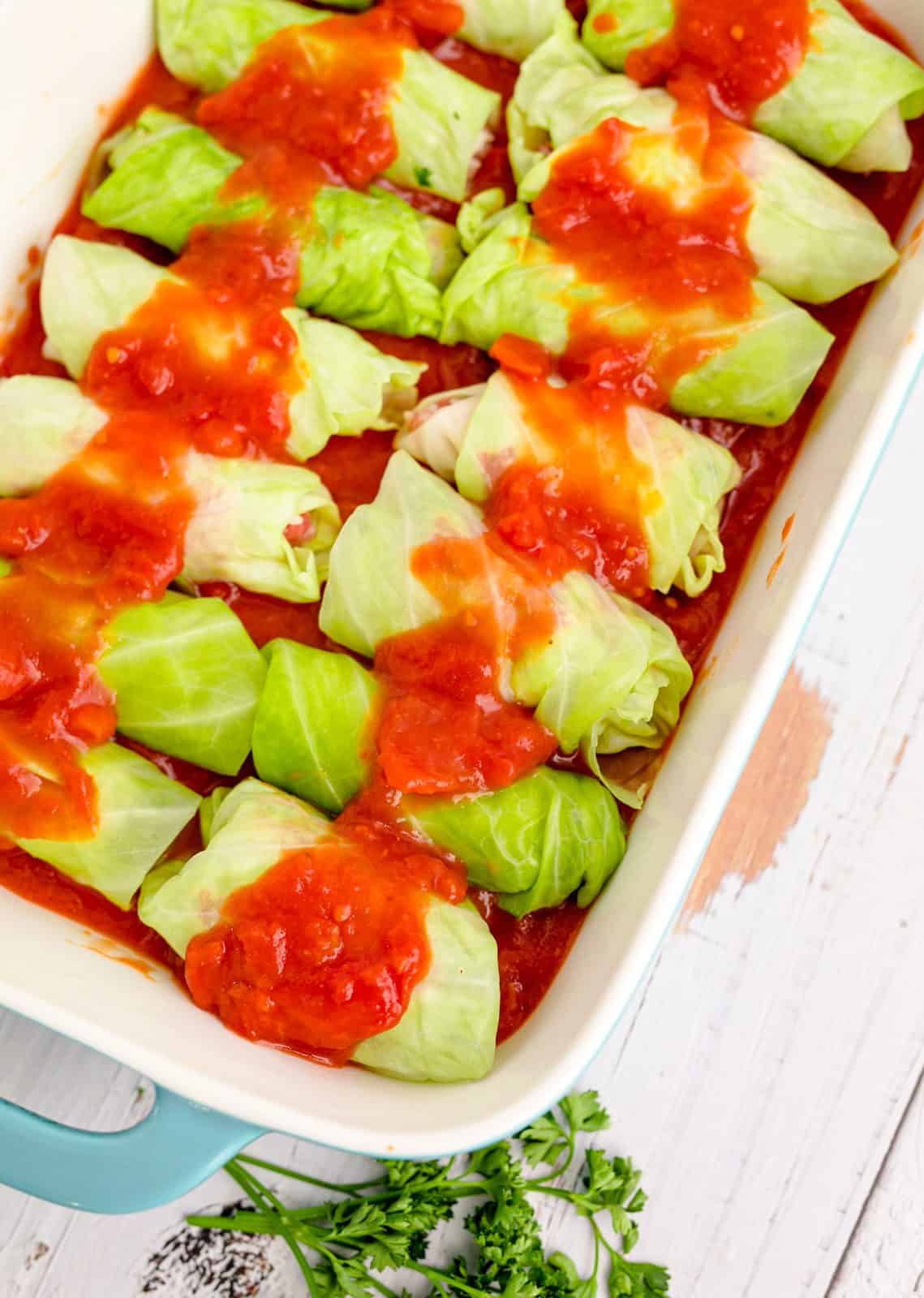 Cabbage rolls placed in baking dish and covered with remaining sauce.