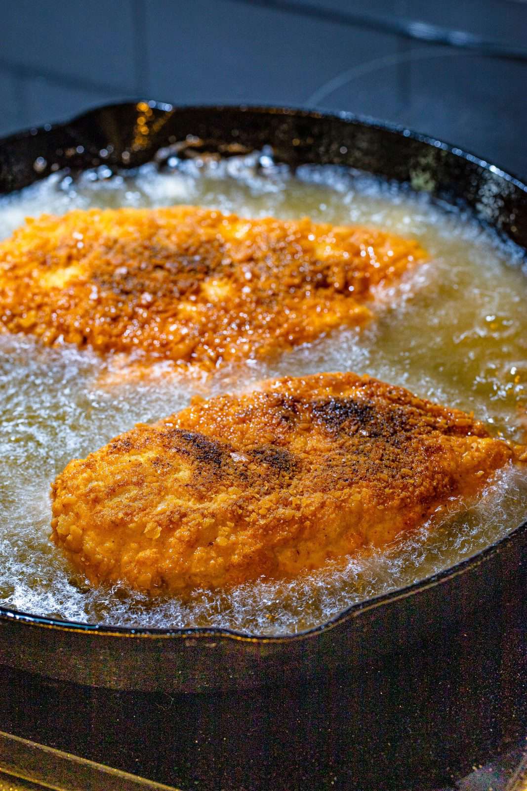Chicken being fried in oil.
