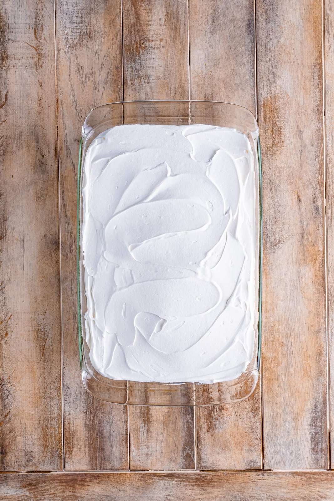 whipped cream spread over the baked cake. 