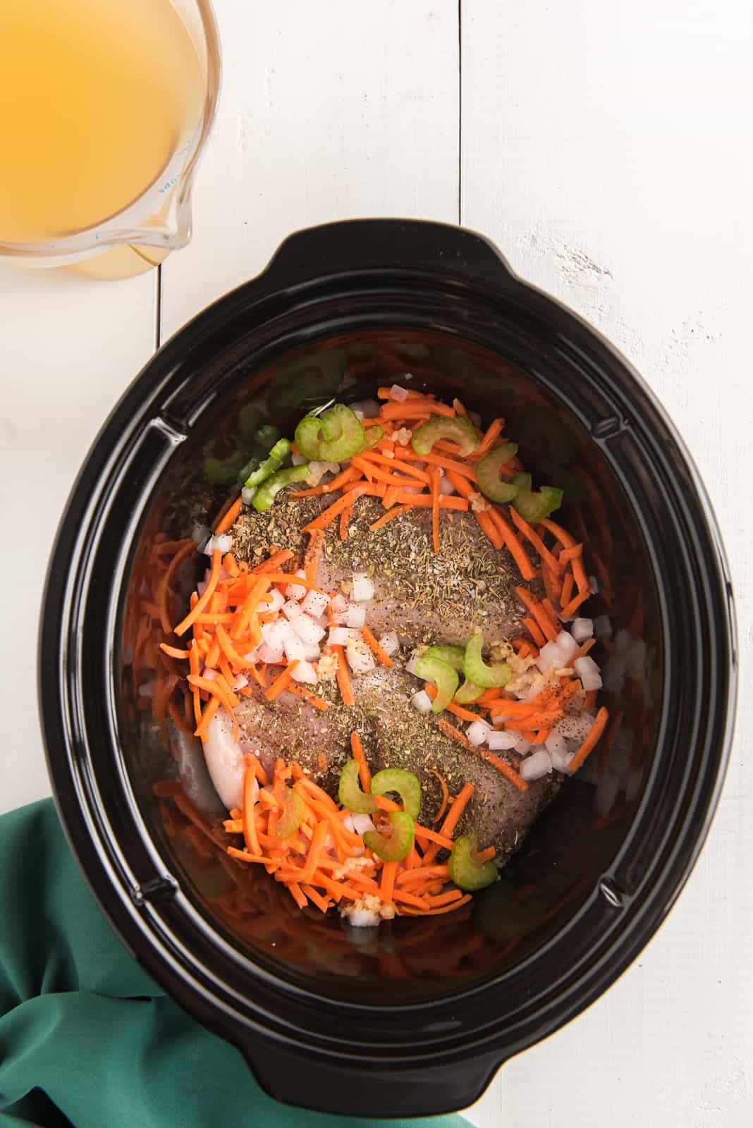 Vegetable, chicken and spice in crock pot.