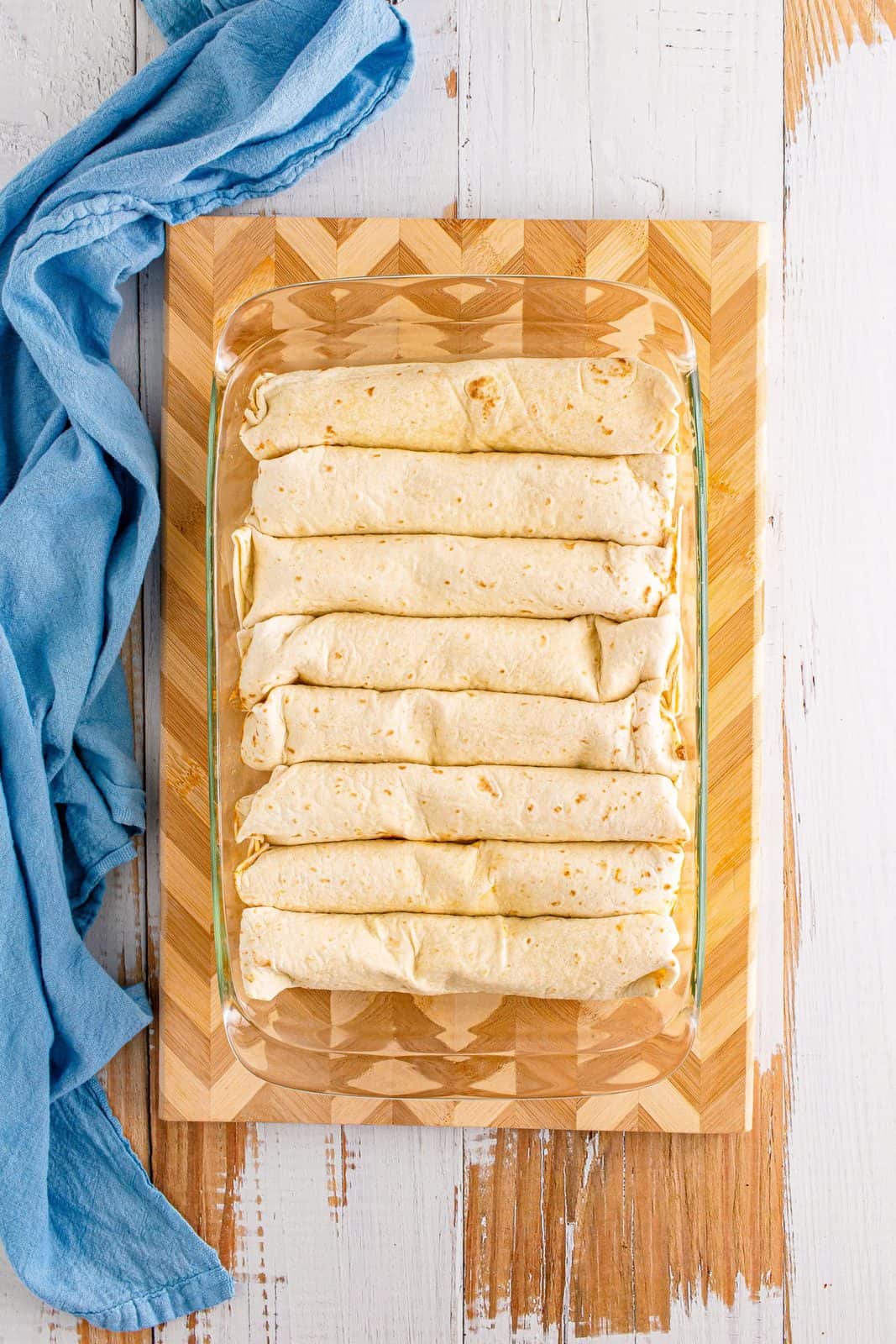Rolled up enchiladas in pan.