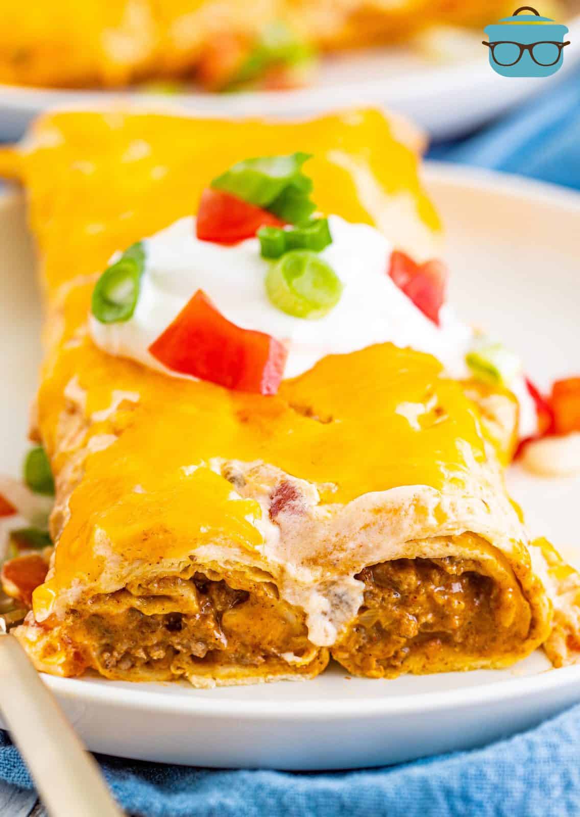 Close up of Ground Beef Enchiladas on plate showing ends and inside.
