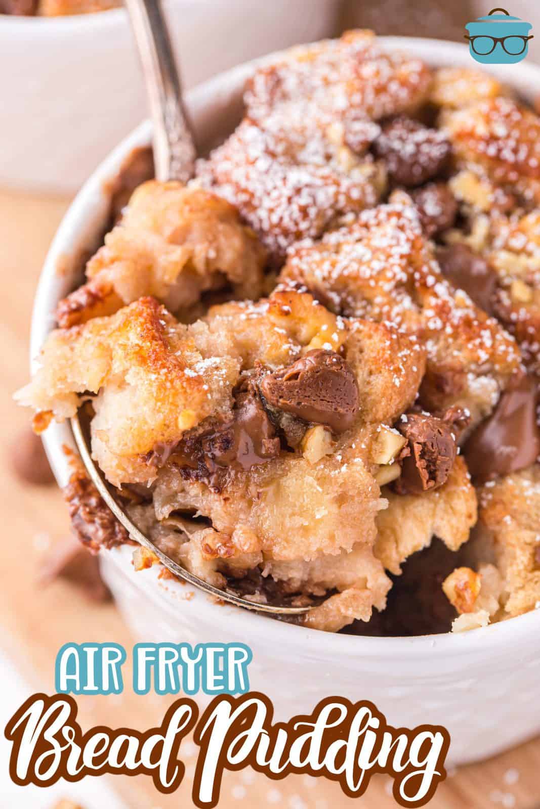 Pinterest image close up of Air Fryer Bread Pudding with some on spoon.