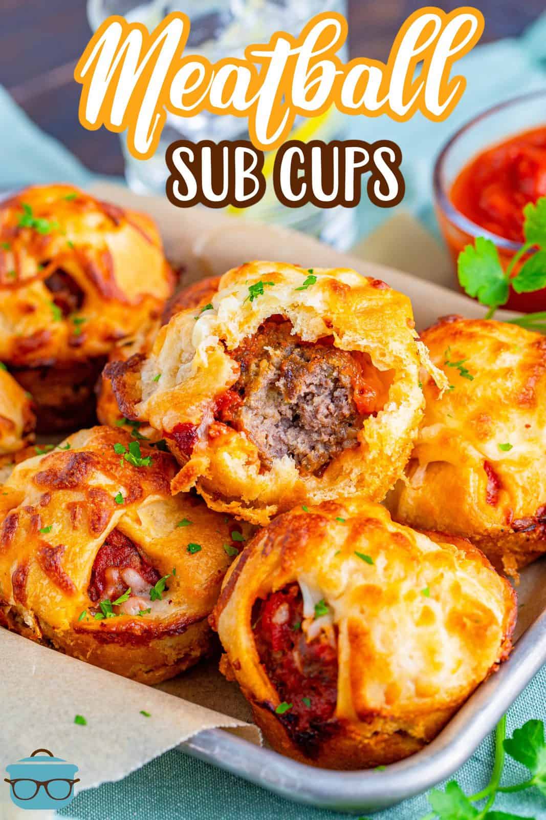 Pinterest image of Meatball Sub Cups stacked on top of one another with bite taken out of top one.