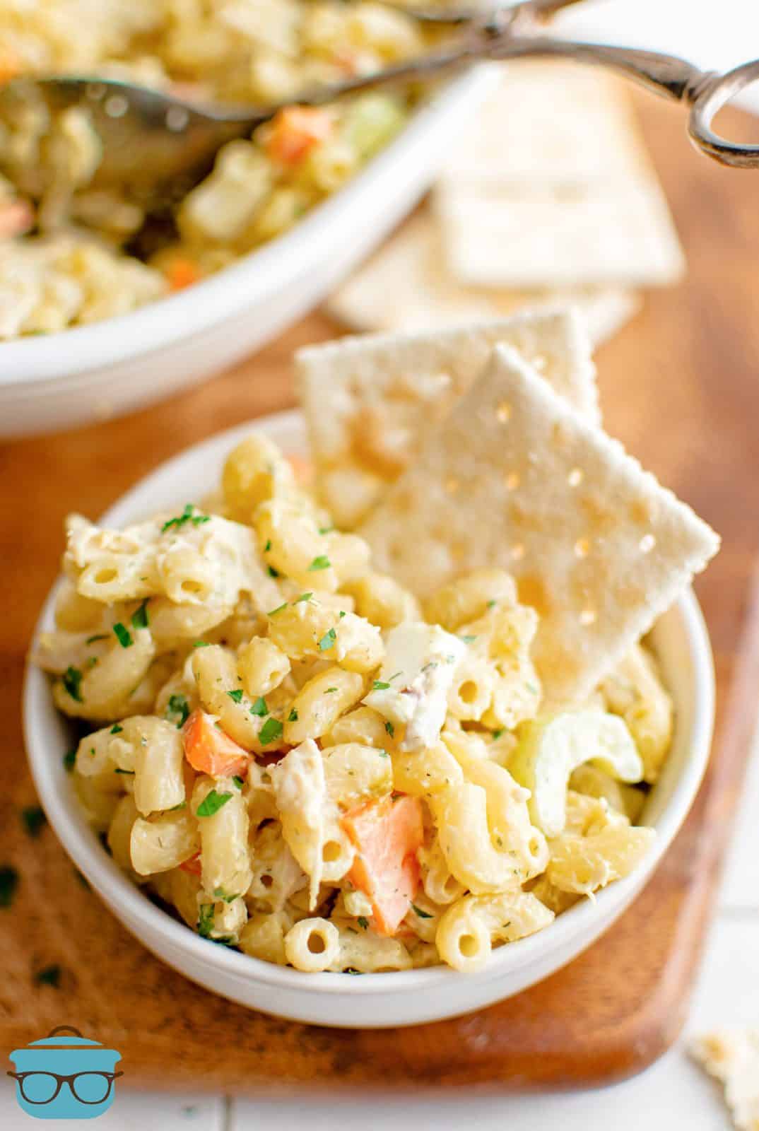 Bowl of Chicken Macaroni Salad with saltine crackers sticking out.