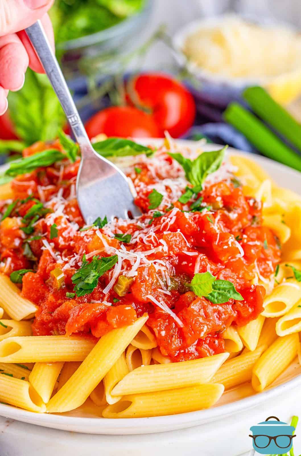 Easy Tomato Basil Sauce over pasta with fork in sauce.