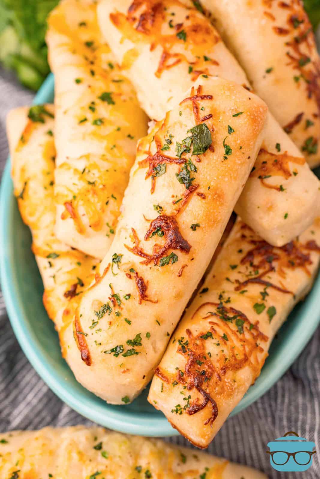 Overhead stacked Cheese Stuffed Breadsticks in bowl.