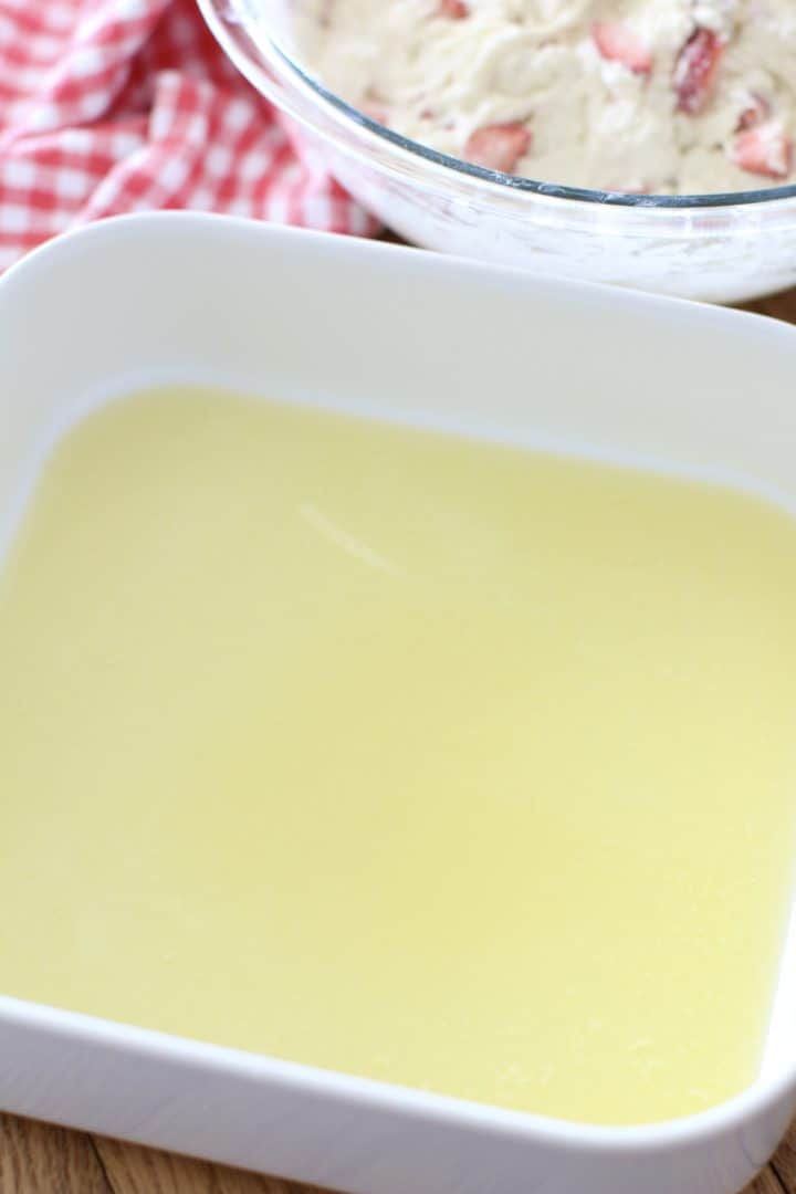 melted butter in a white baking dish.