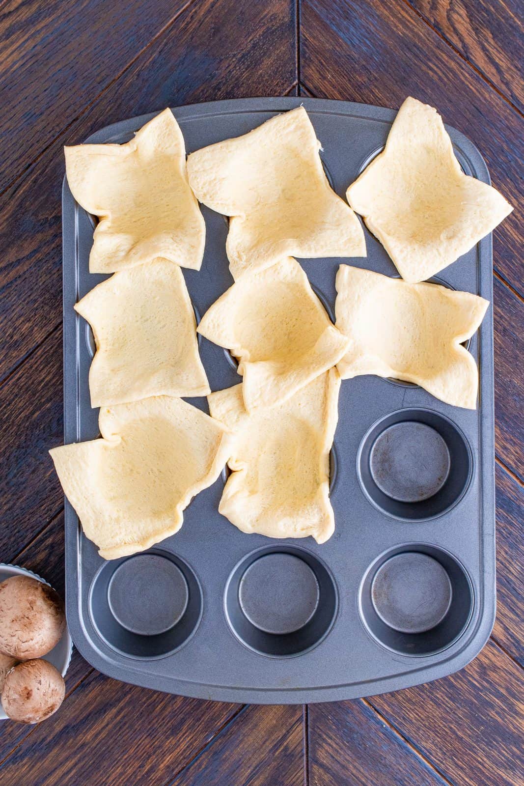 Cut up crescent dough sheet and placed into muffin tin.