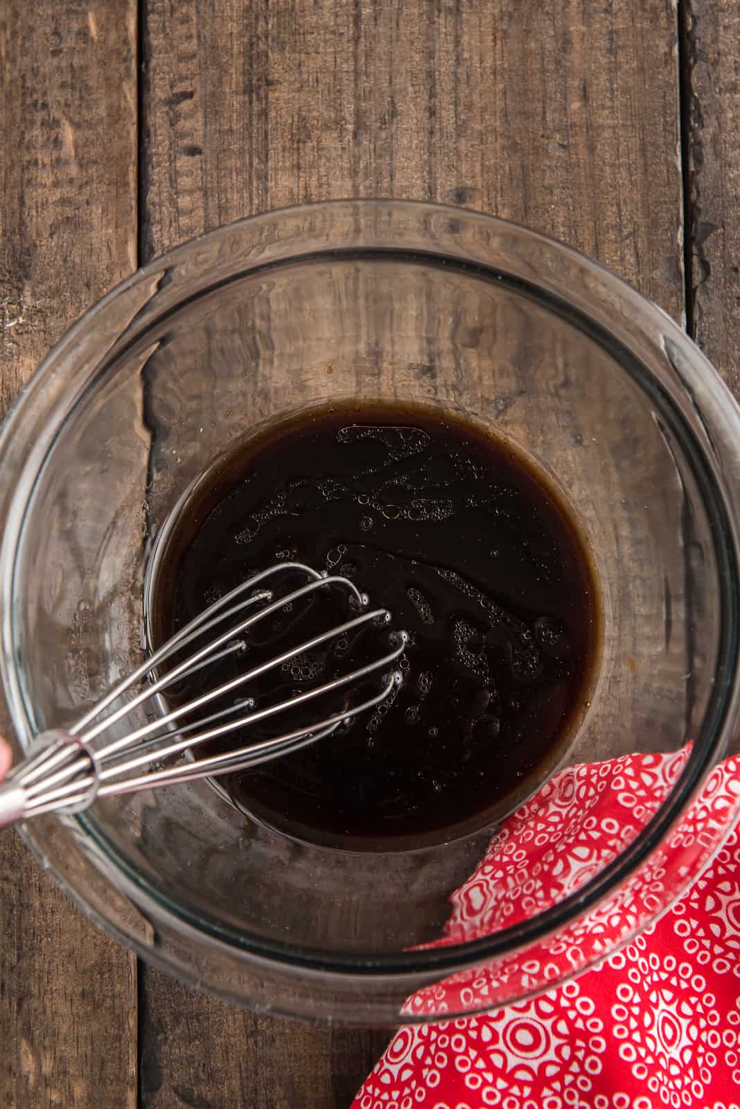 Brown sugar, hoisin sauce, soy sauce, sesame oil, and rice vinegar whisked together in bowl.