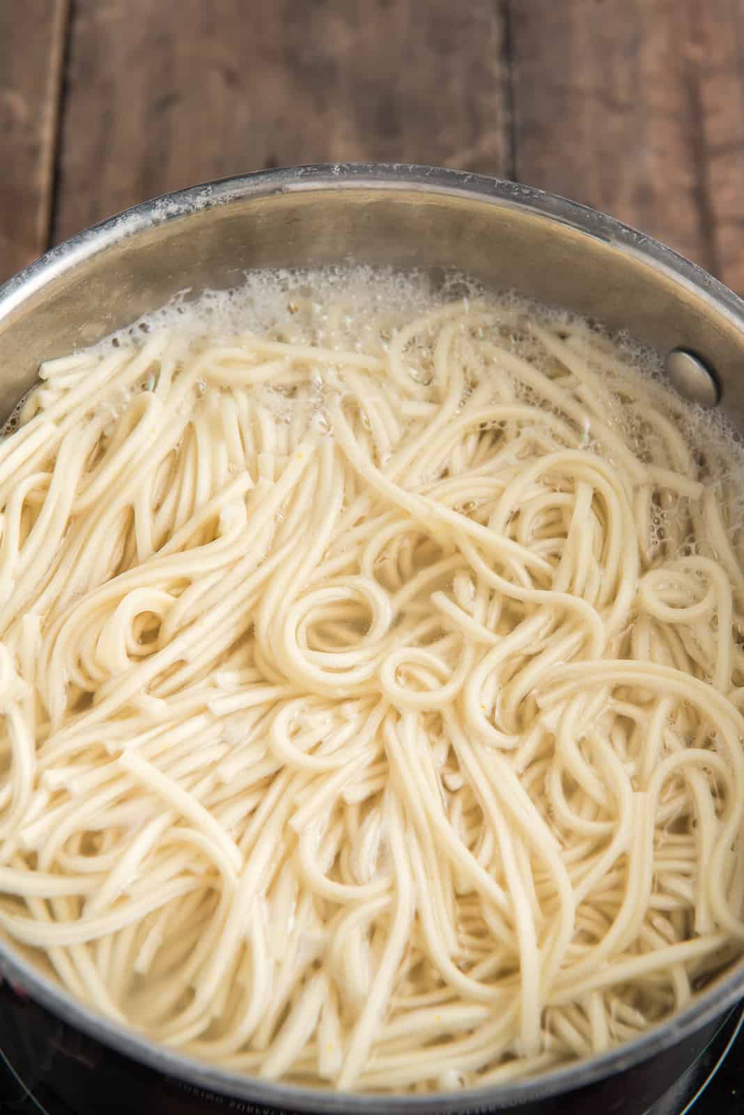 Noodles being cooked in pot.