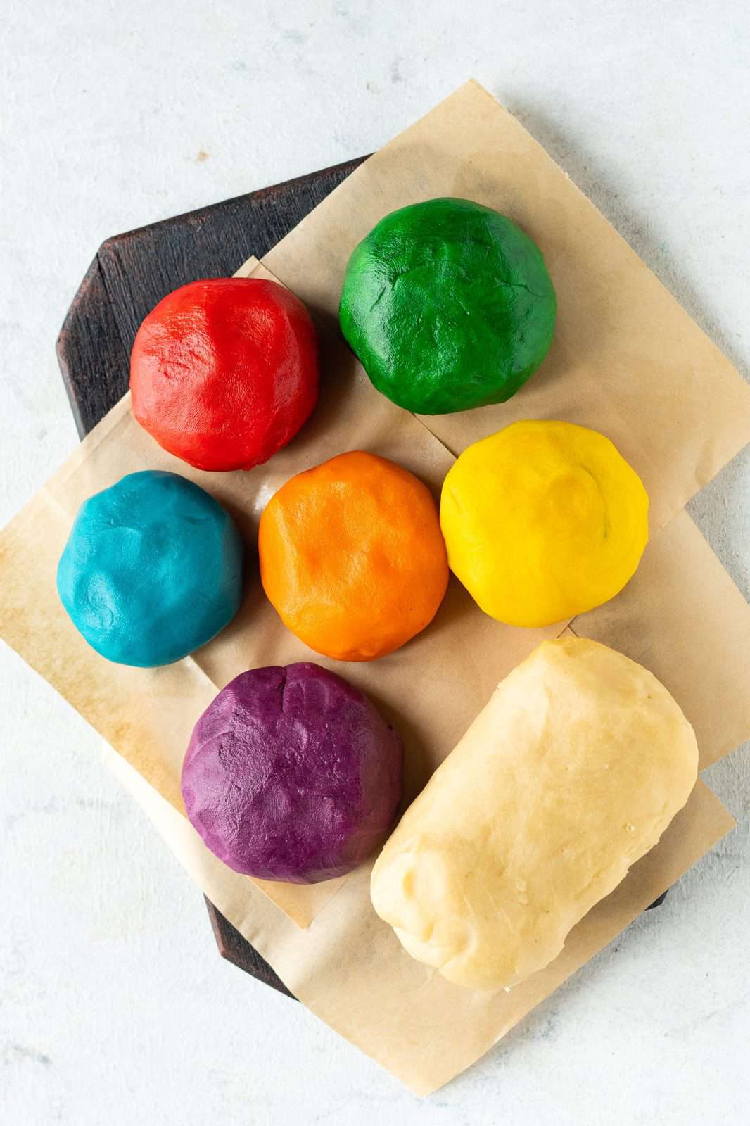 Six of the dough balls colored with one dough left the same.