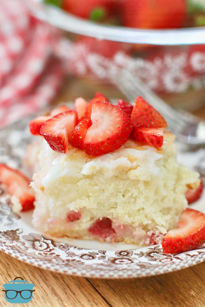 Strawberry Butter Dip Biscuit on a plate and topped with sliced fresh strawberries.