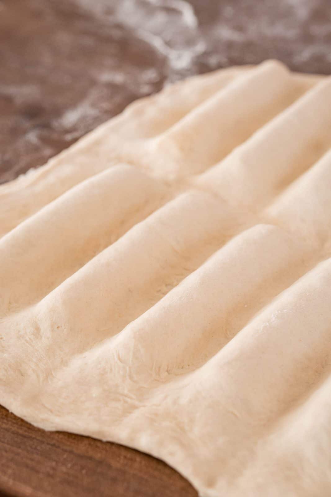 Pizza dough pressed around breadsticks and edges.