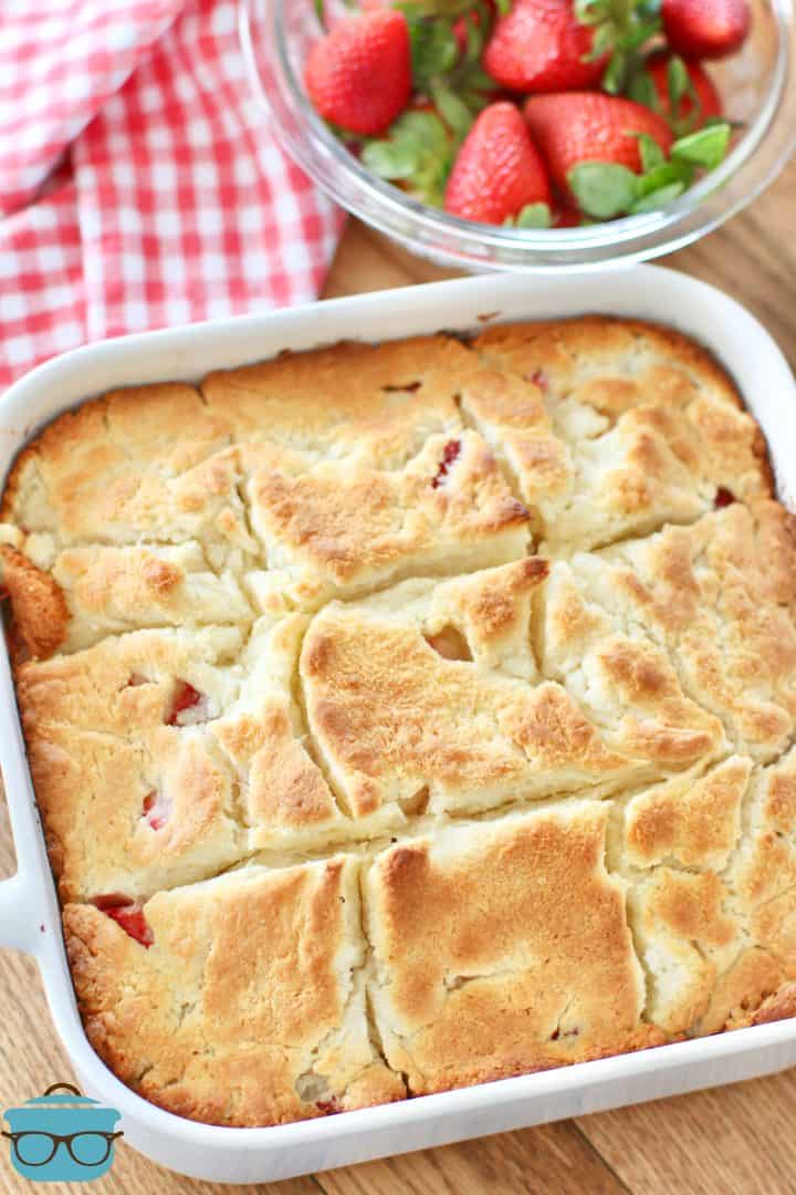 fully baked Strawberry Butter Swim Biscuits in a square white baking dish.