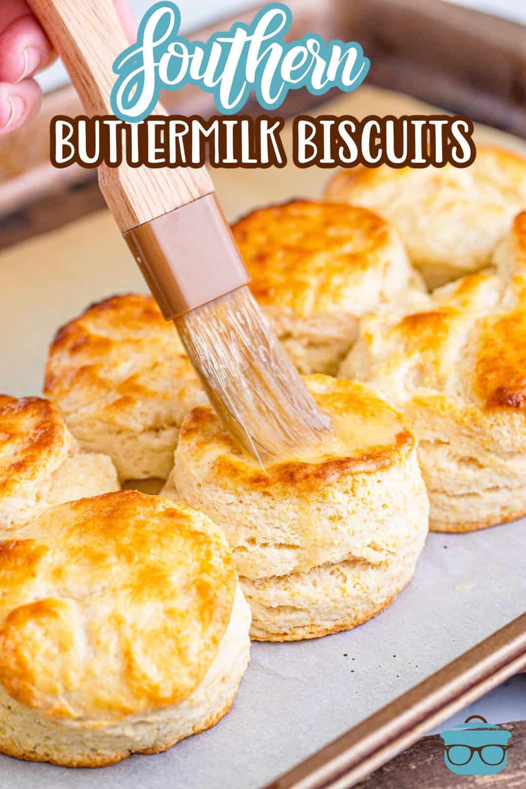 Pinterest image of pastry brush brushing melted butter on Southern Buttermilk Biscuits.