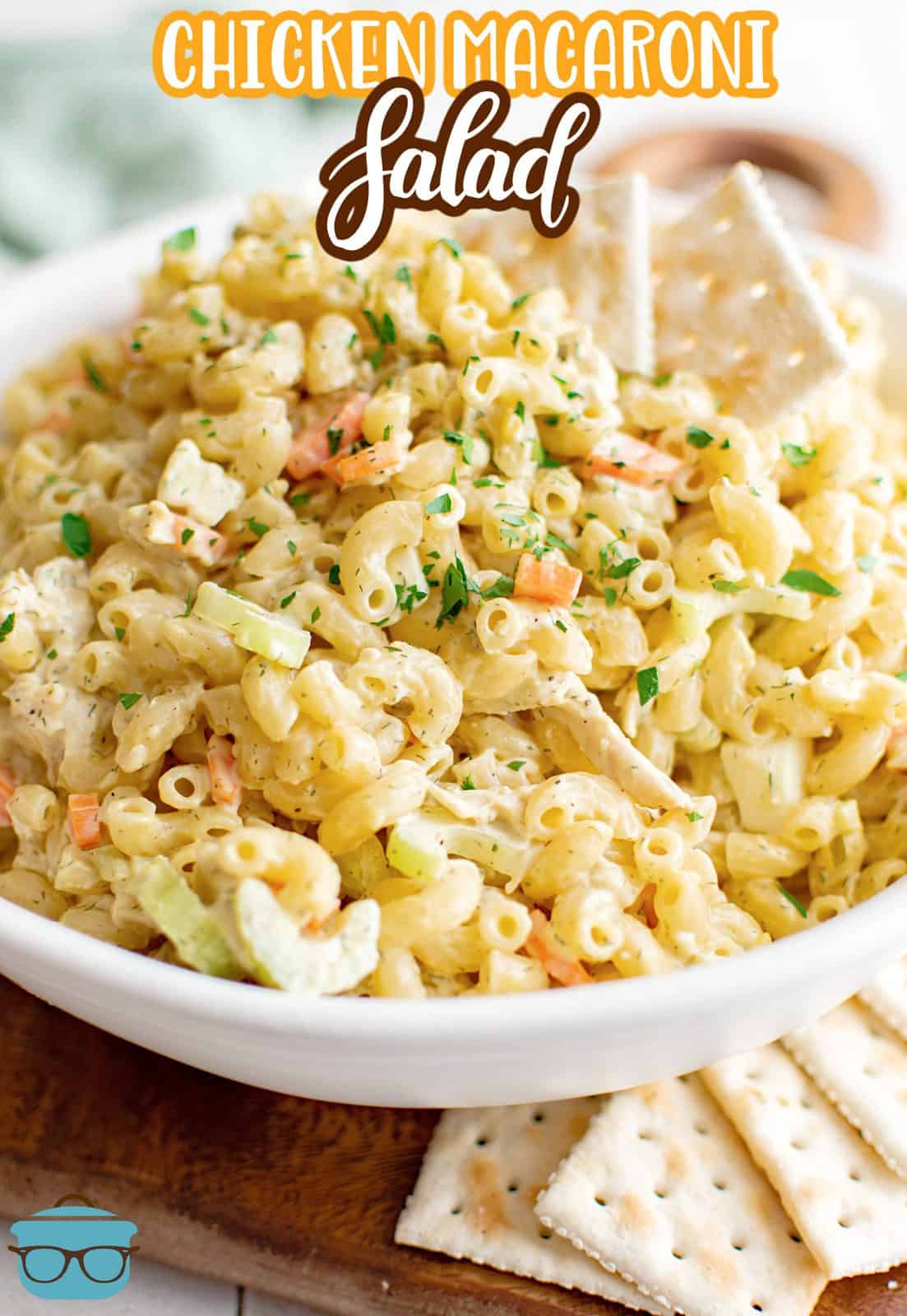 Pinterest image of Chicken Macaroni Salad in white bowl with saltine crackers in the top.