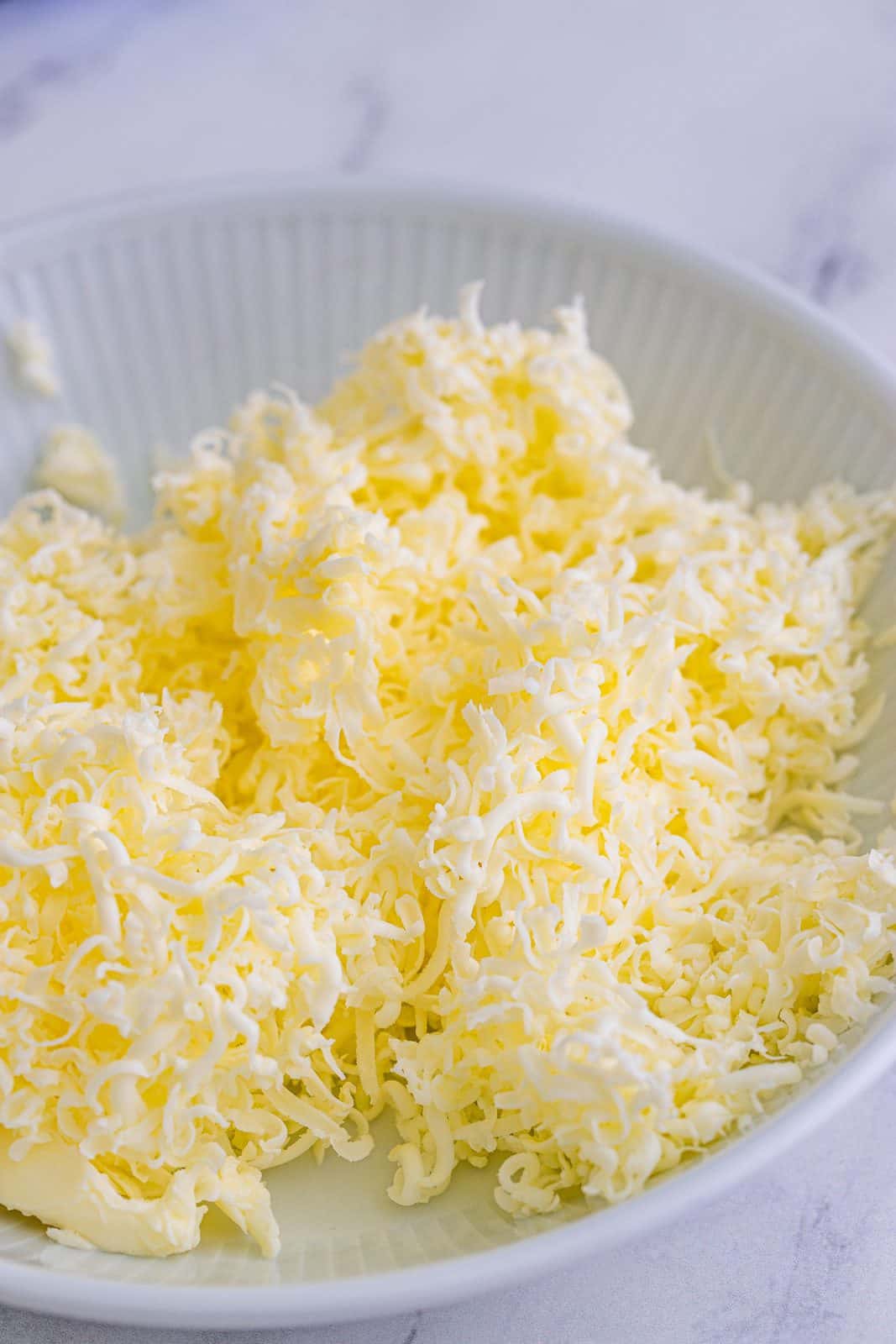 Grated butter in bowl.