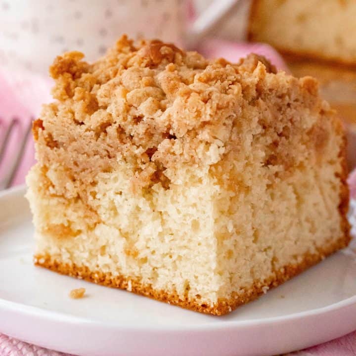 Square image of Bisquick Coffee Cake slice on white plate.