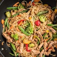 Close up square image of Chicken Lo Mein in wok.