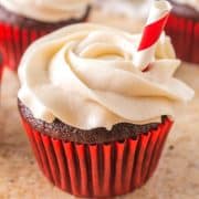 Square image of frosted Coca Cola Cupcake with straw.