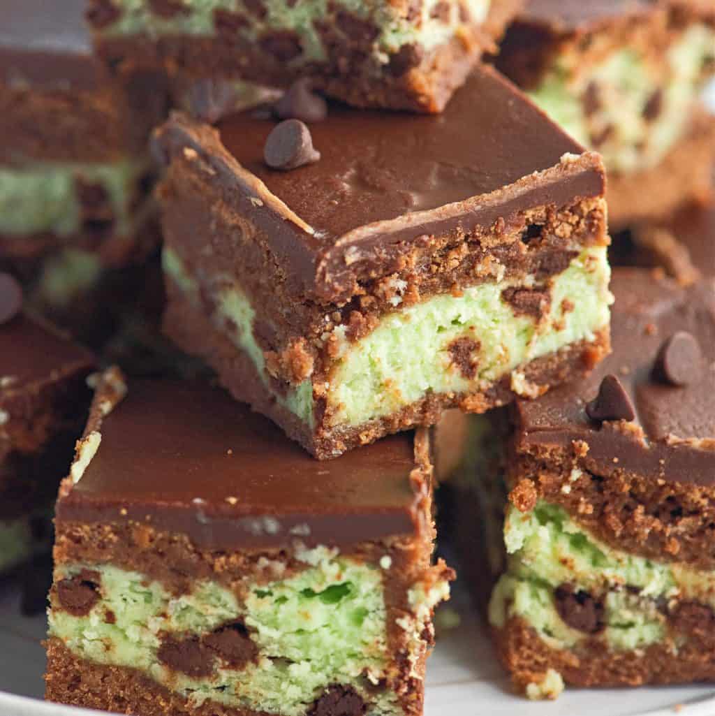 Square image showing layers of stacked Mint Cream Cheese Brownies.