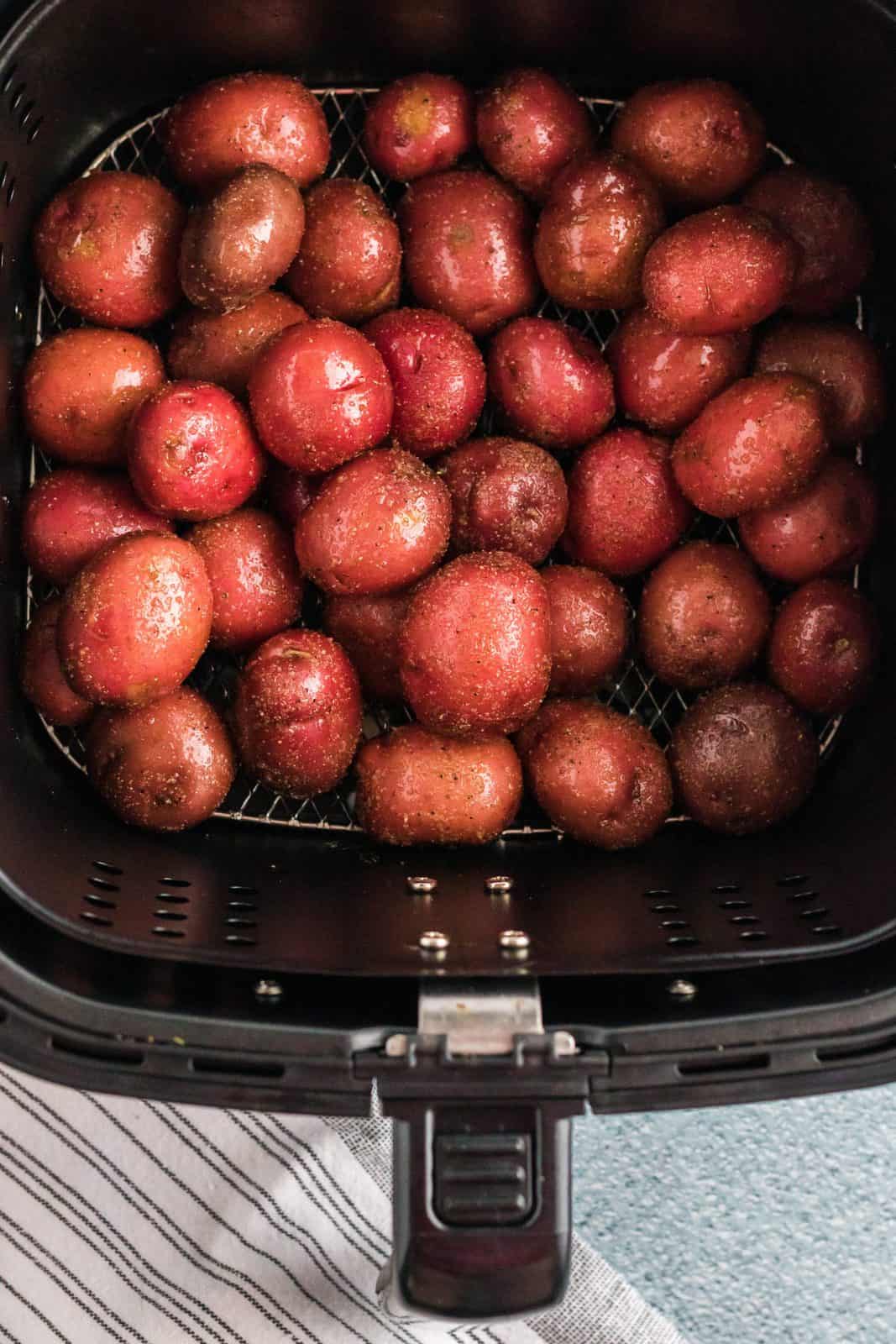 Baby potatoes placed in air fryer basket.