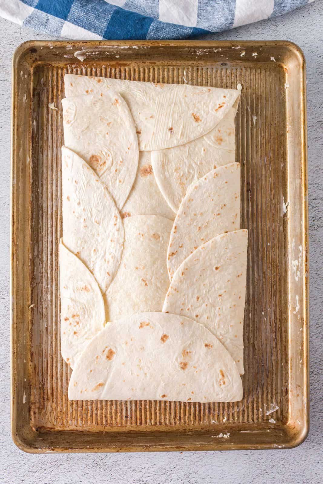 Tortillas folded over the top to encase the filling.