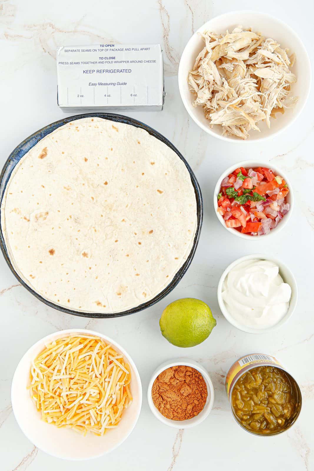 Ingredients needed: chicken, cream cheese, green chiles, taco seasoning, mexican cheese, tortillas and optional toppings.