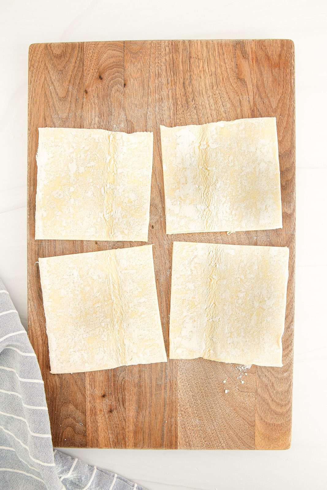Puff pastry sheet cut into squares.