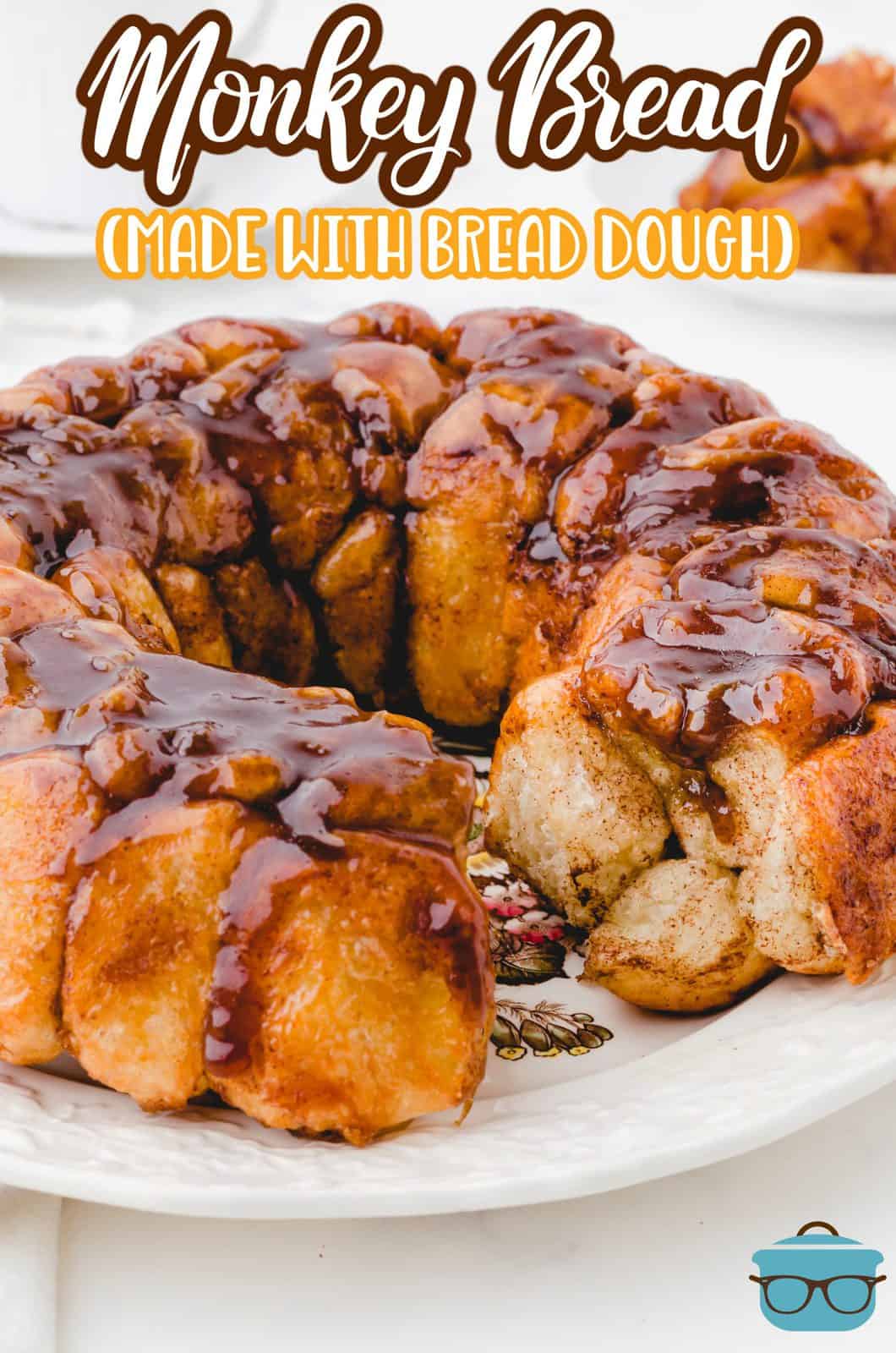 Pinterest image of Easy Monkey Bread on platter with some bread removed.