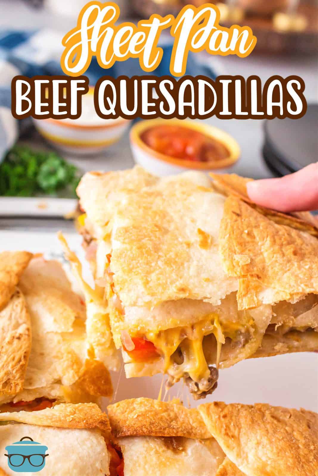 Pinterest image of hand holding up one slice of the Sheet Pan Beef Quesadillas.