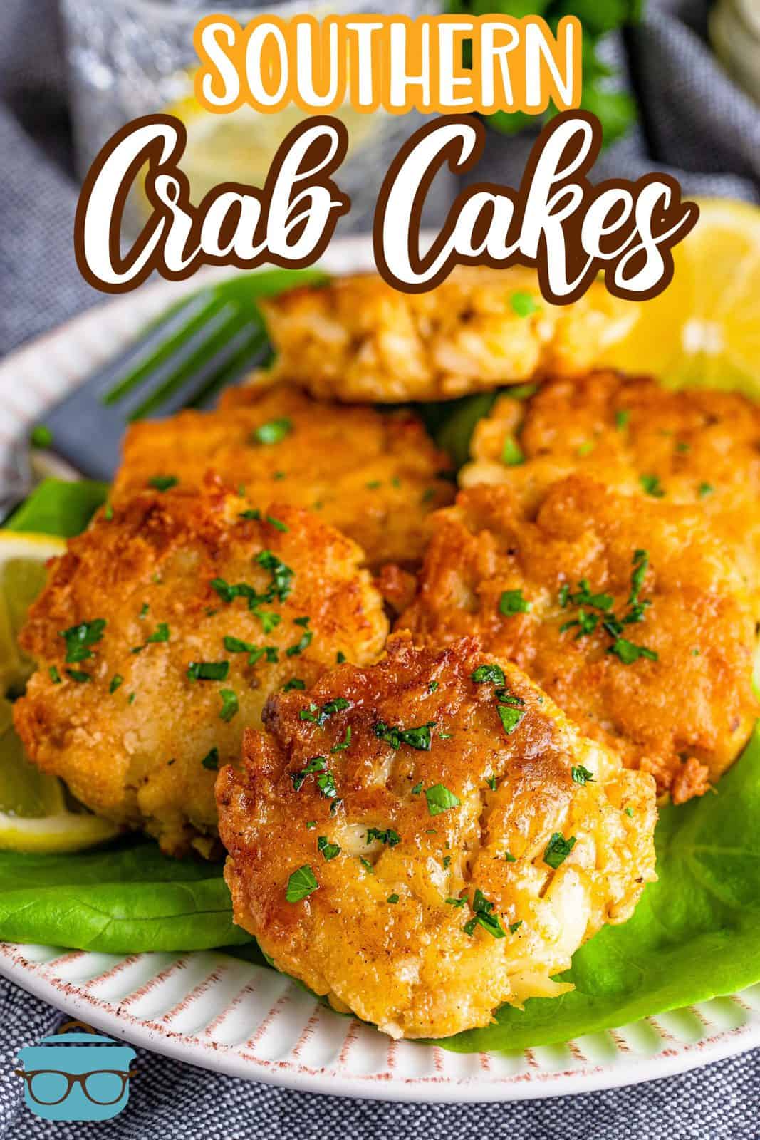 Pinterest image of stacked Southern Crab Cakes on lettuce on white plate.