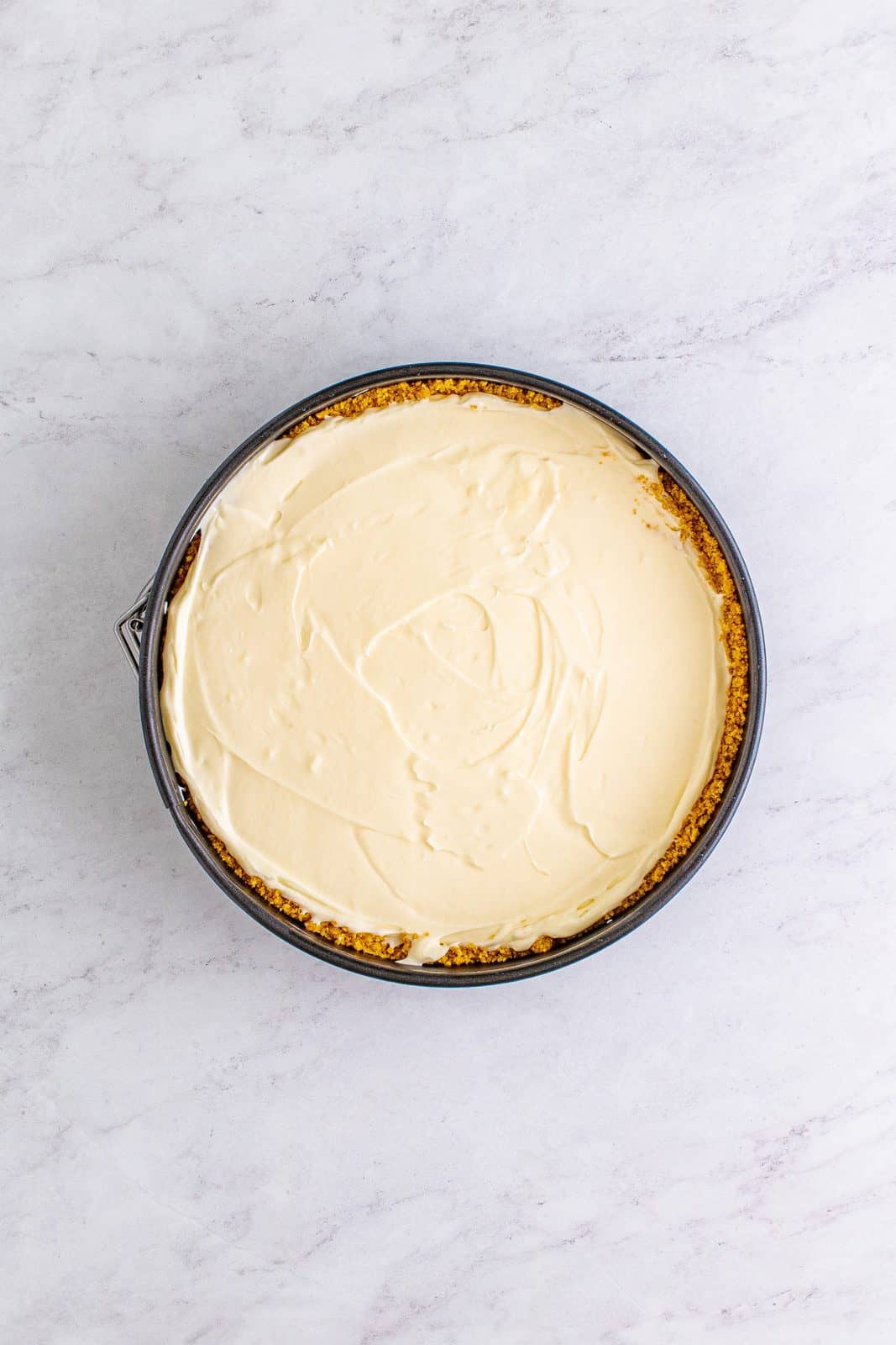 Cheesecake mixture spread into pan with crust.