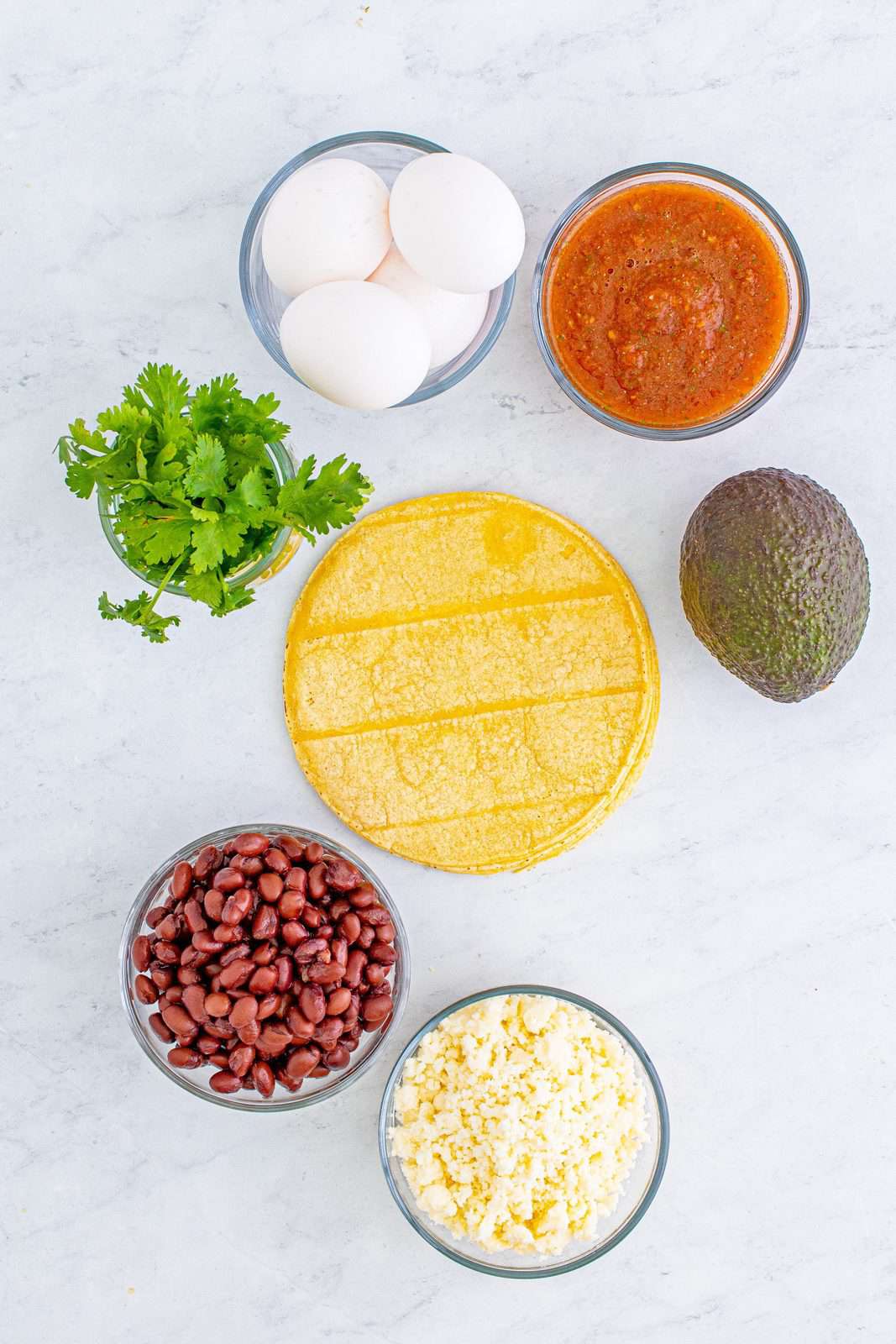 Ingredients needed: corn tortillas, eggs, black beans or ½ cup refried beans and optional toppings.