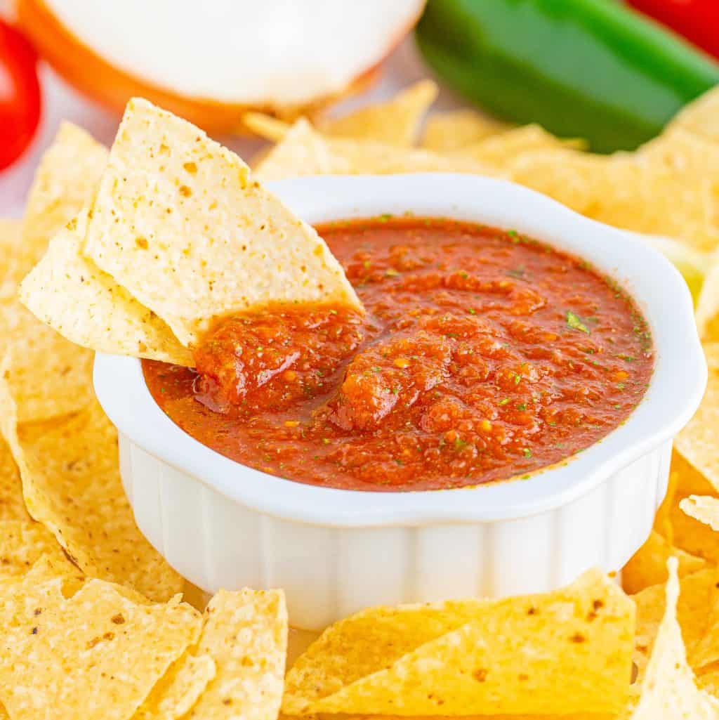 Square image close up of Blender Salsa in bowl with two chips.