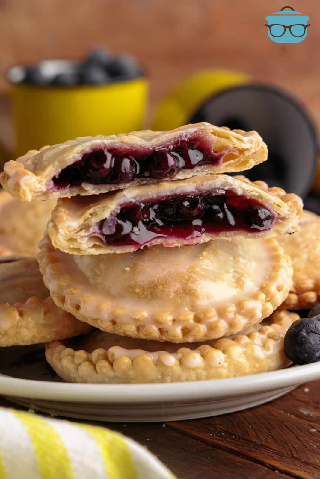 Layered Air Fryer Blueberry Hand Pies on plate with top on split open showing inside.