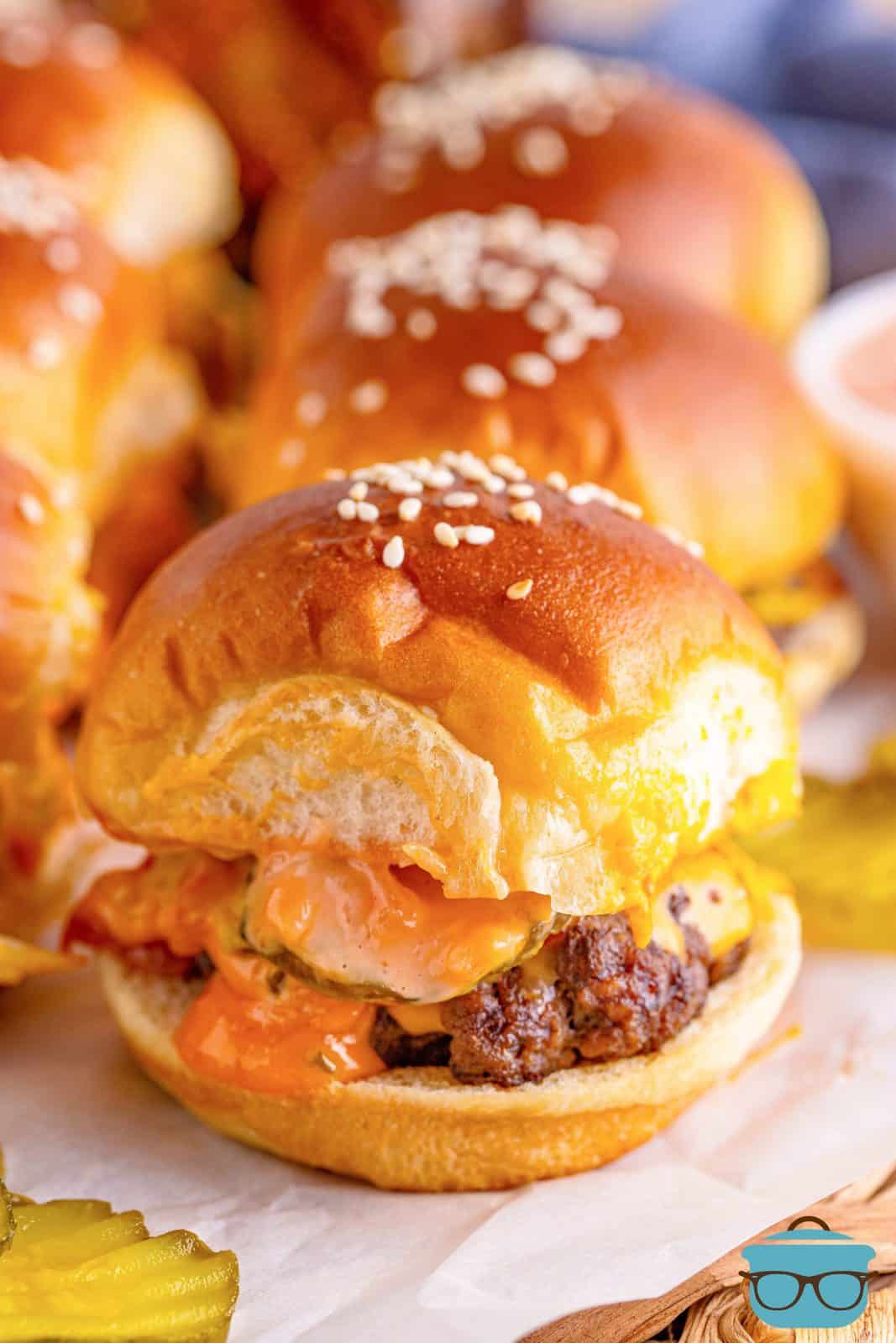 Close up of one Big Mac Slider showing sauce and melted cheese.