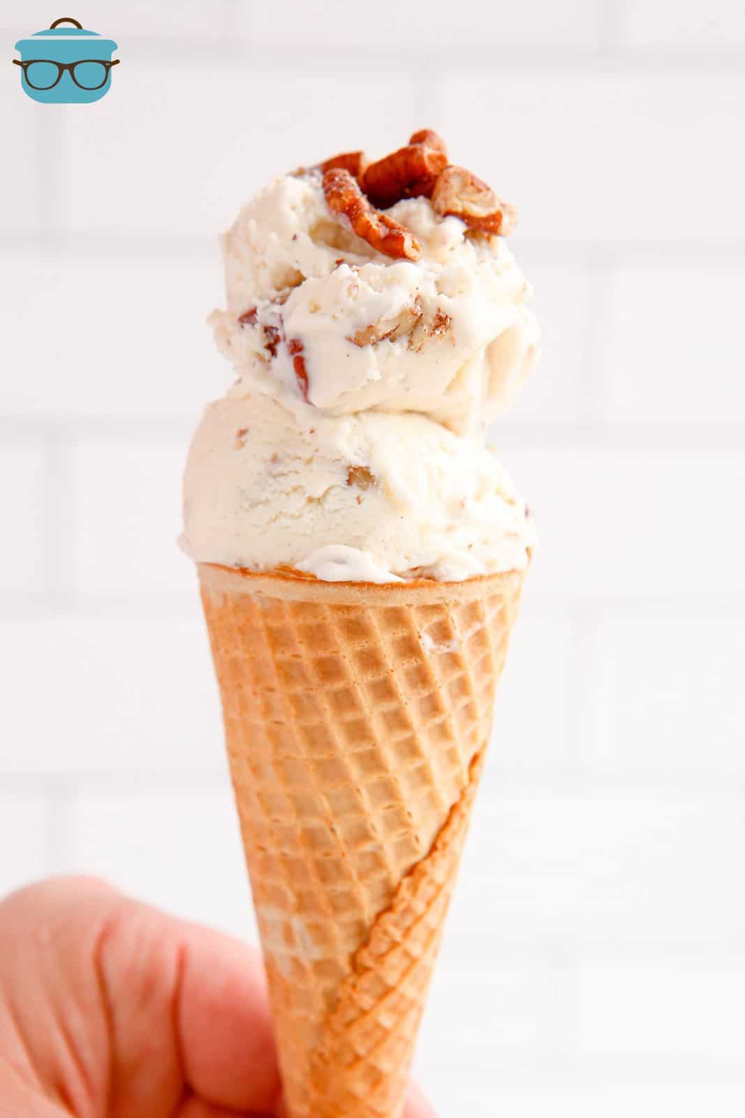 No-Churn Butter Pecan Ice Cream being held by hand in ice cream cone.