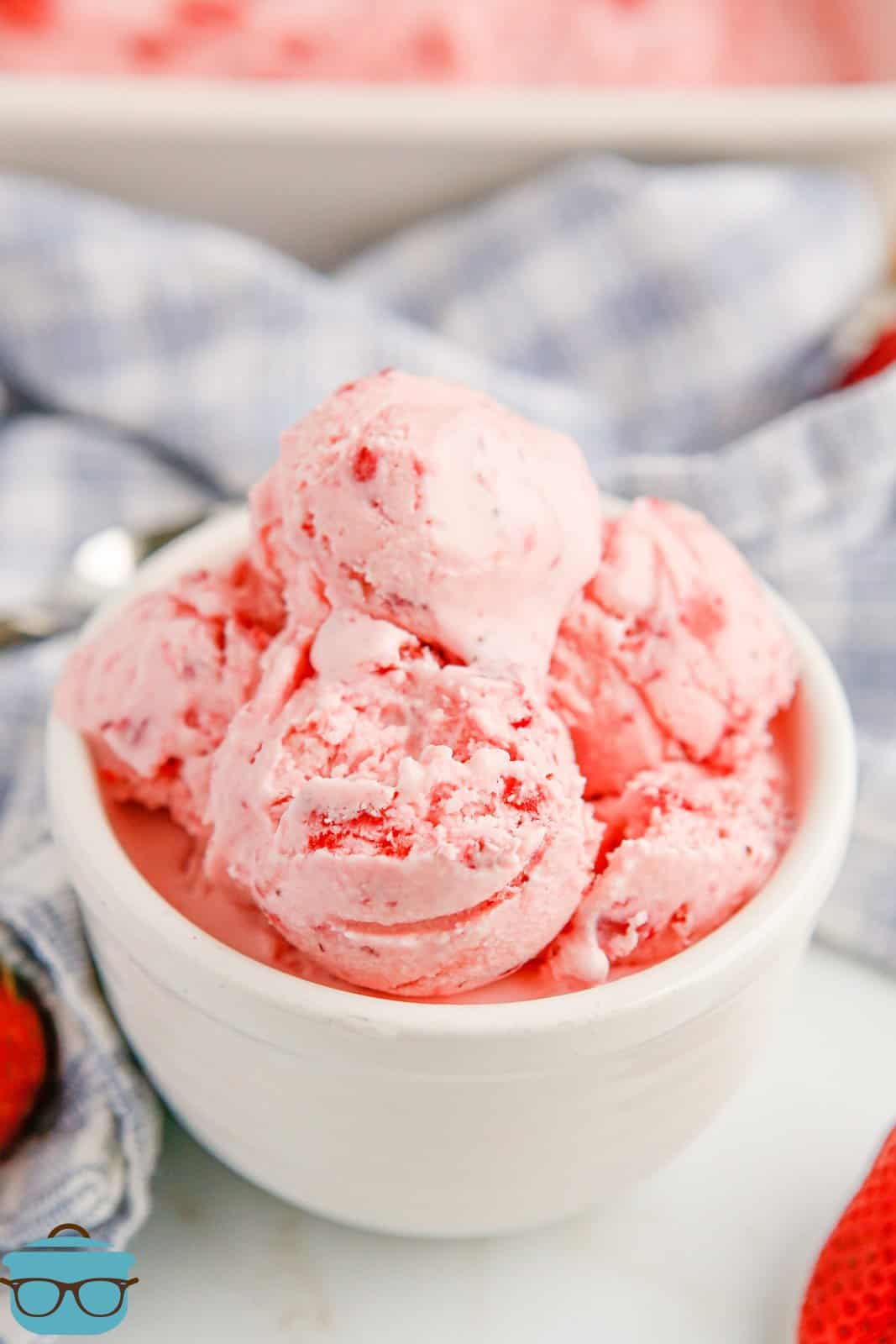 Scoops of No-Churn Strawberry Ice Cream on white bowl.