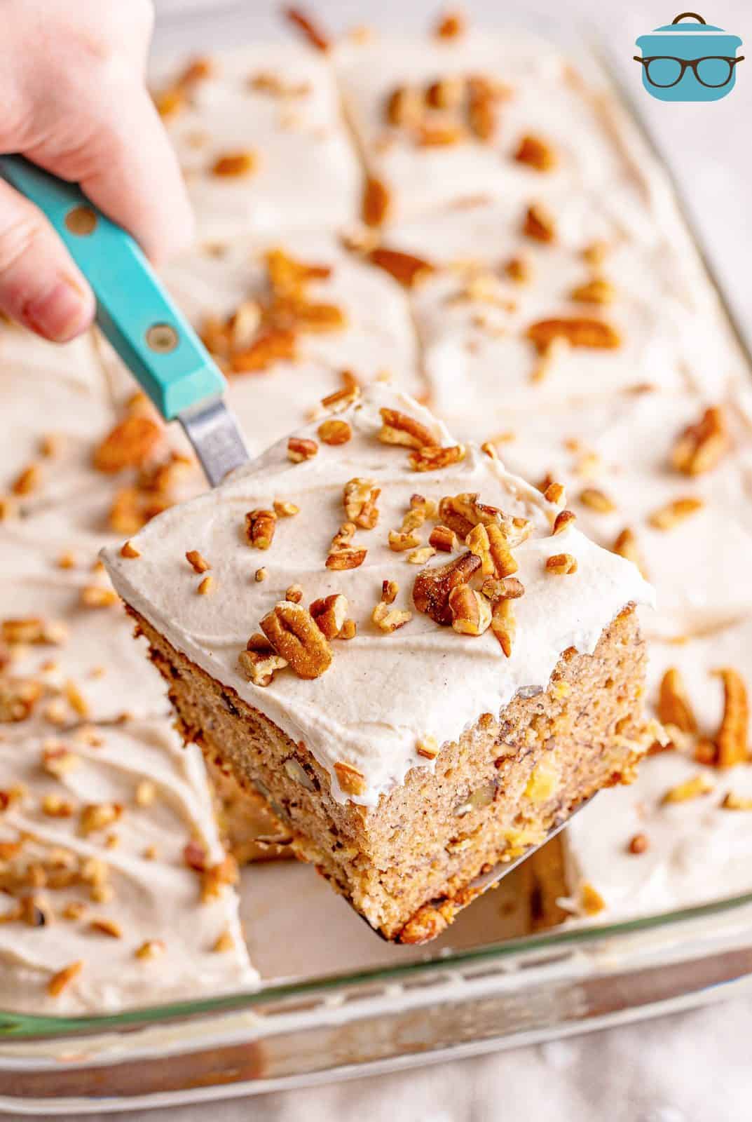 Spatula holding up one slice of Hummingbird Cake out of pan.