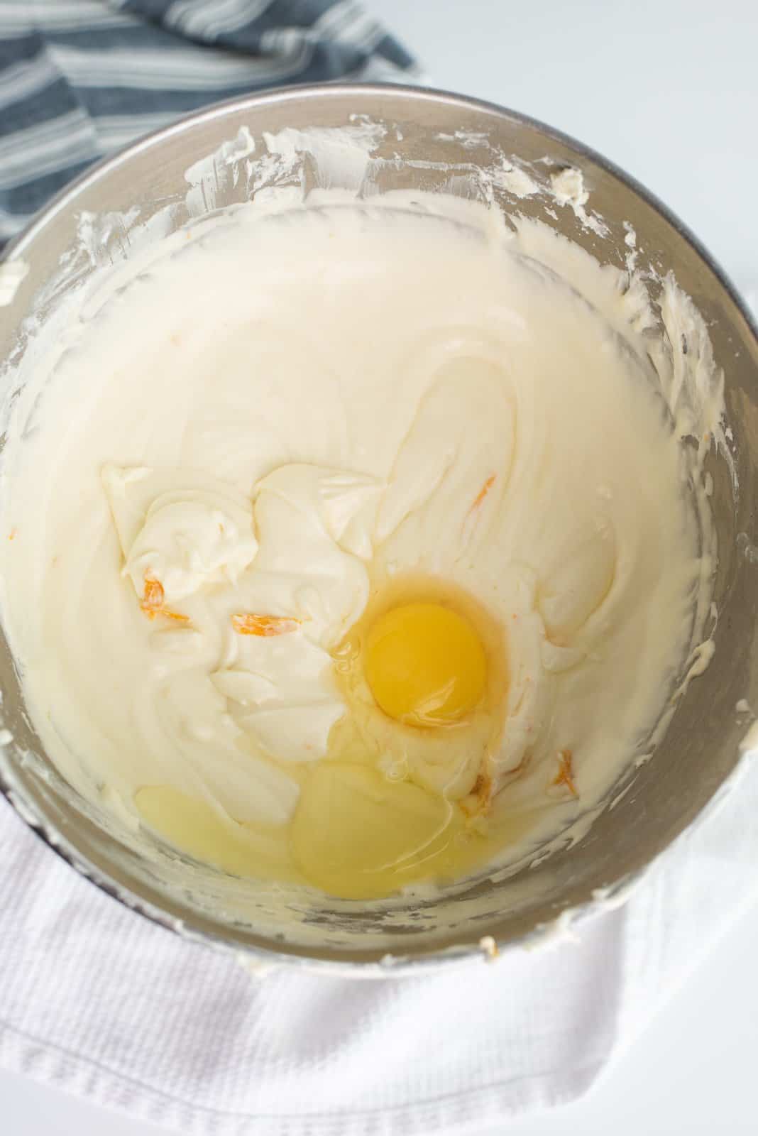 Eggs and heavy cream added to cheesecake mixture.