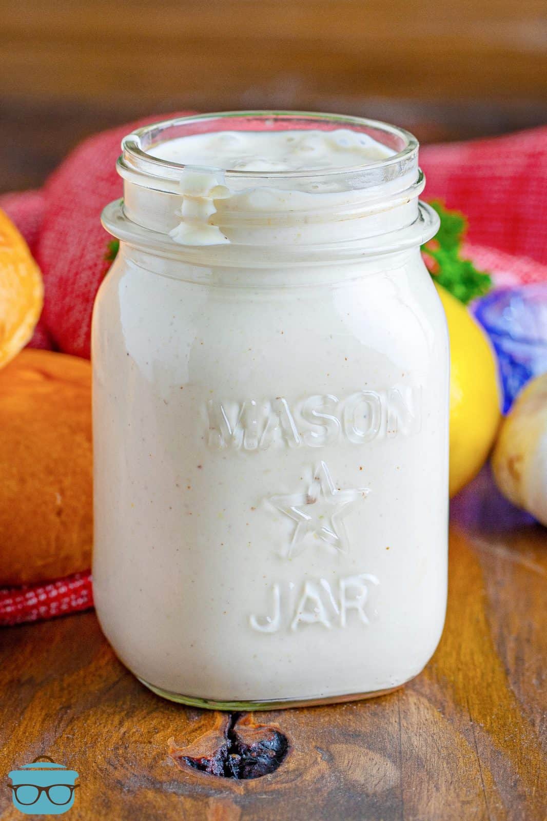 Close up of mason jar with Alabama White Sauce in it.