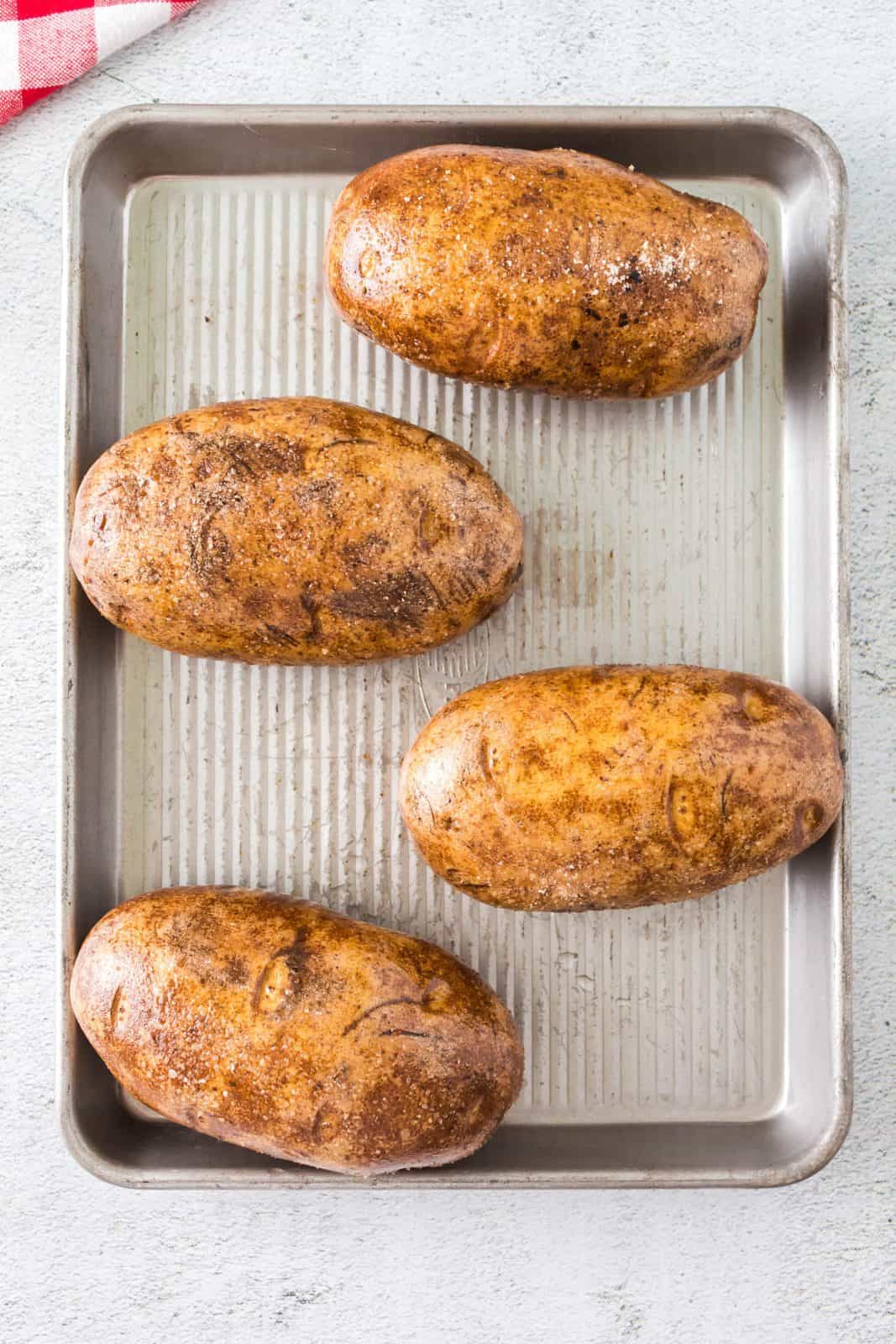 Seasoned potatoes on baking pan.