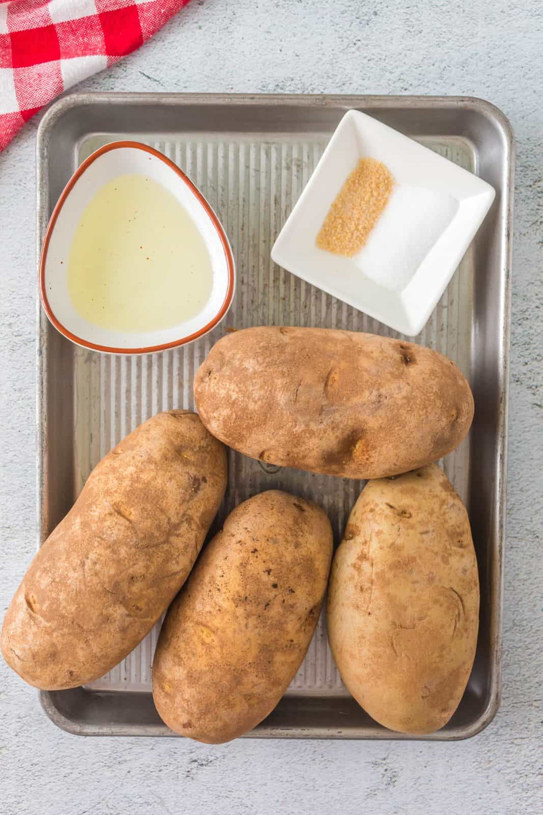 Ingredients needed: baking potatoes, olive oil, salt and garlic salt.