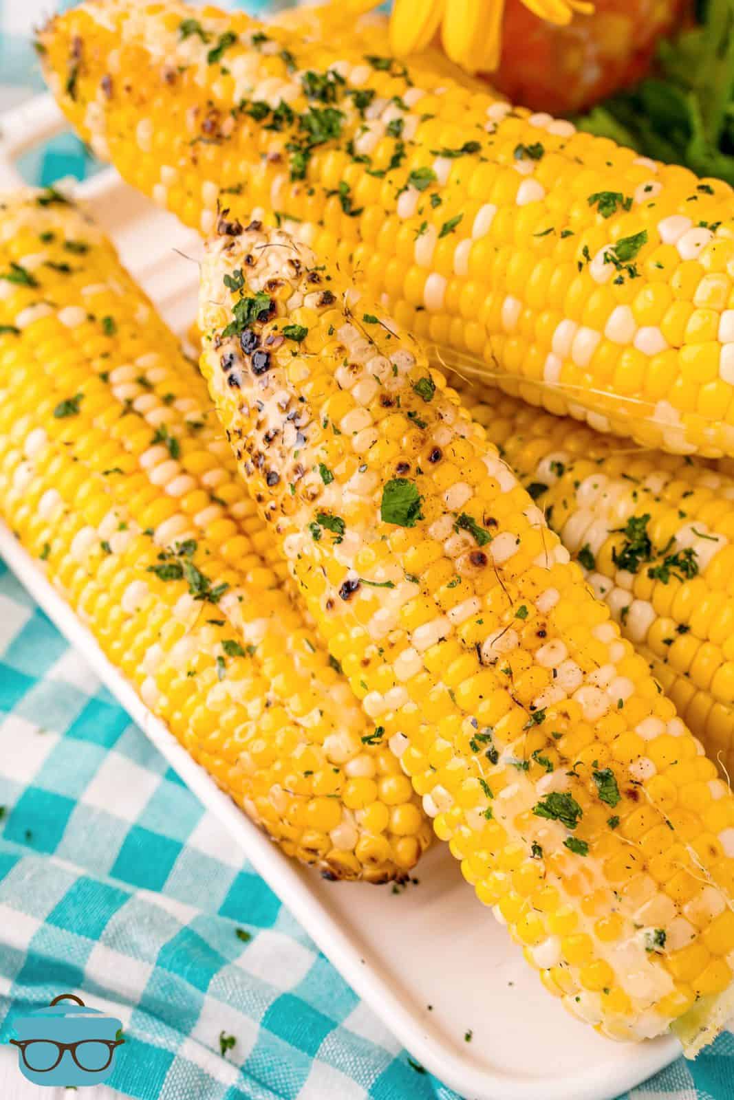 Overhead of Grilled Corn showing butter and herbs.