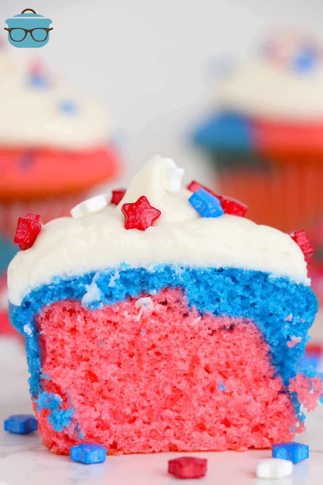 One of the Red, White and Blue Cupcakes cut in half showing the colors of the inside.