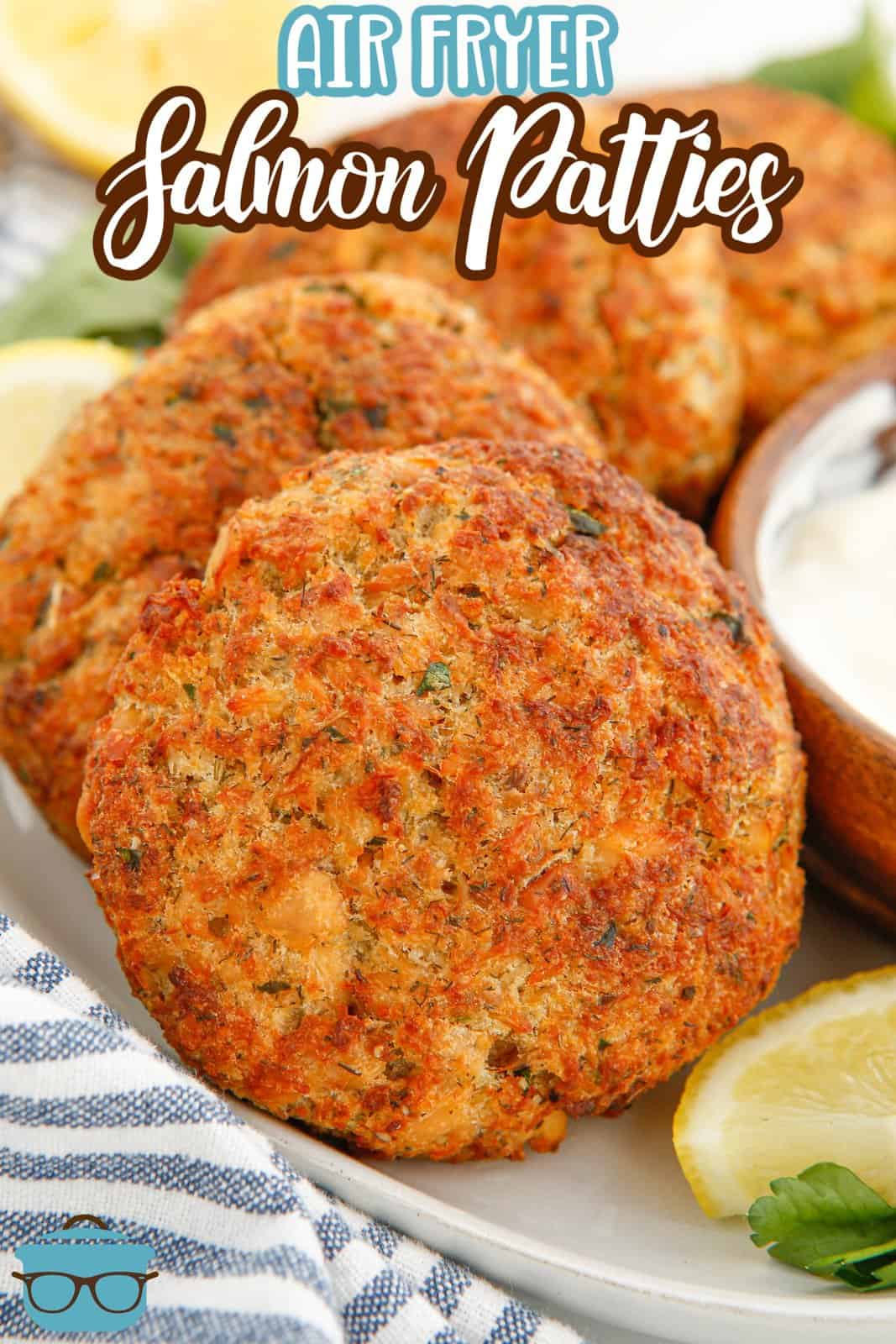 Layered Air Fryer Salmon Patties on plate with lemon and dipping sauce Pinterest image.