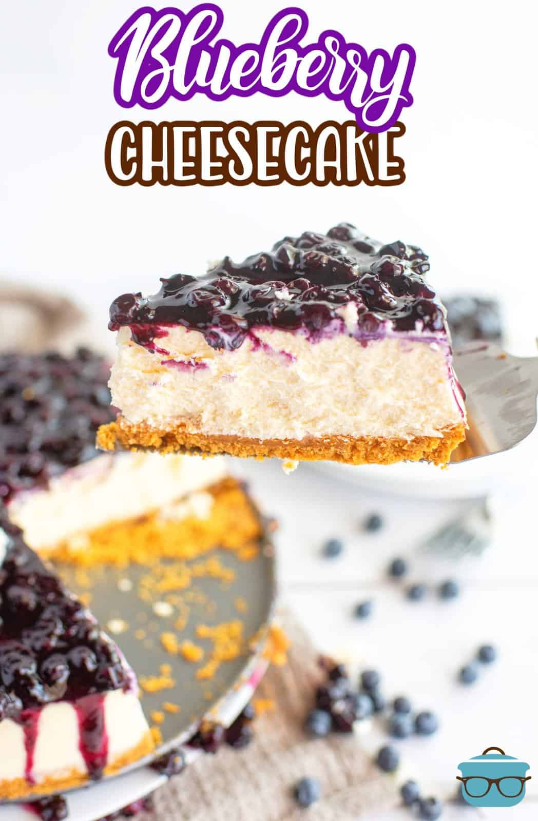 Pie server holding up a slice of Blueberry Cheesecake cut from pan, Pinterest image.